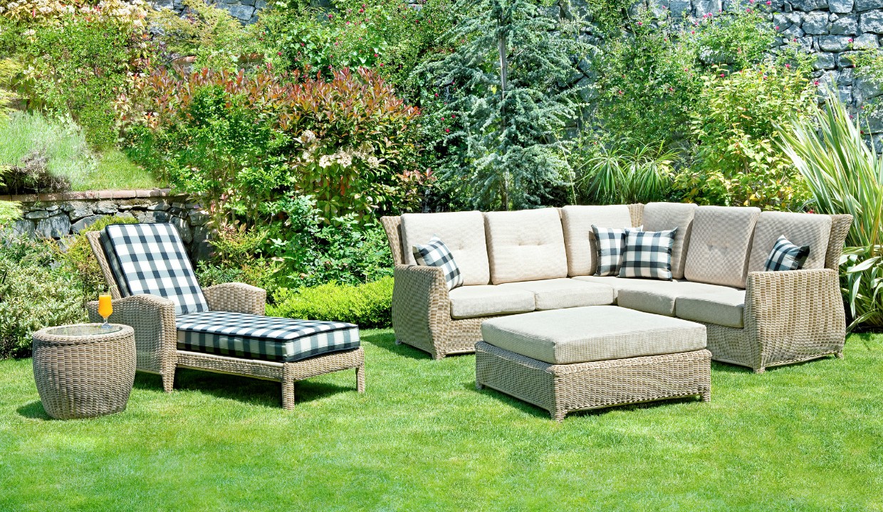 Outdoor couch with lounge chair that have checkered pattern pillows and cushions
