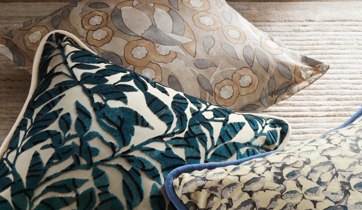 Three pillows with neutral color patterns