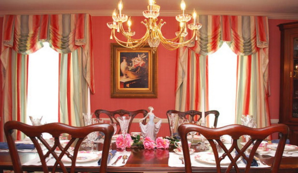 Bright red dining room with windows with valances