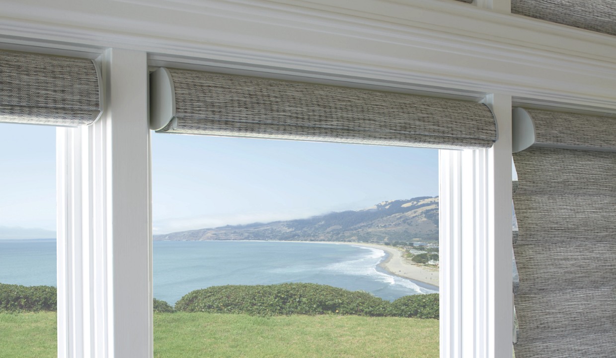 Roman shade on windows overlooking the pacific ocean