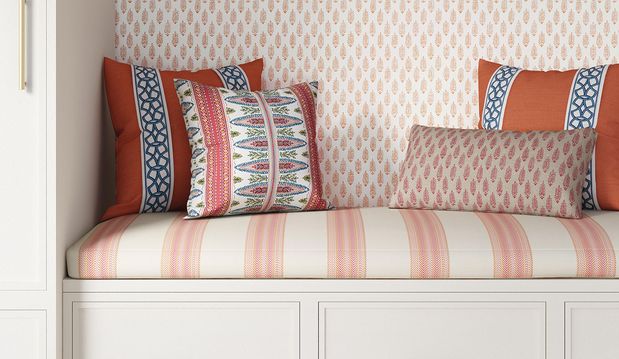 Slipcovers on pillows on a bench with a new patterned slip cover