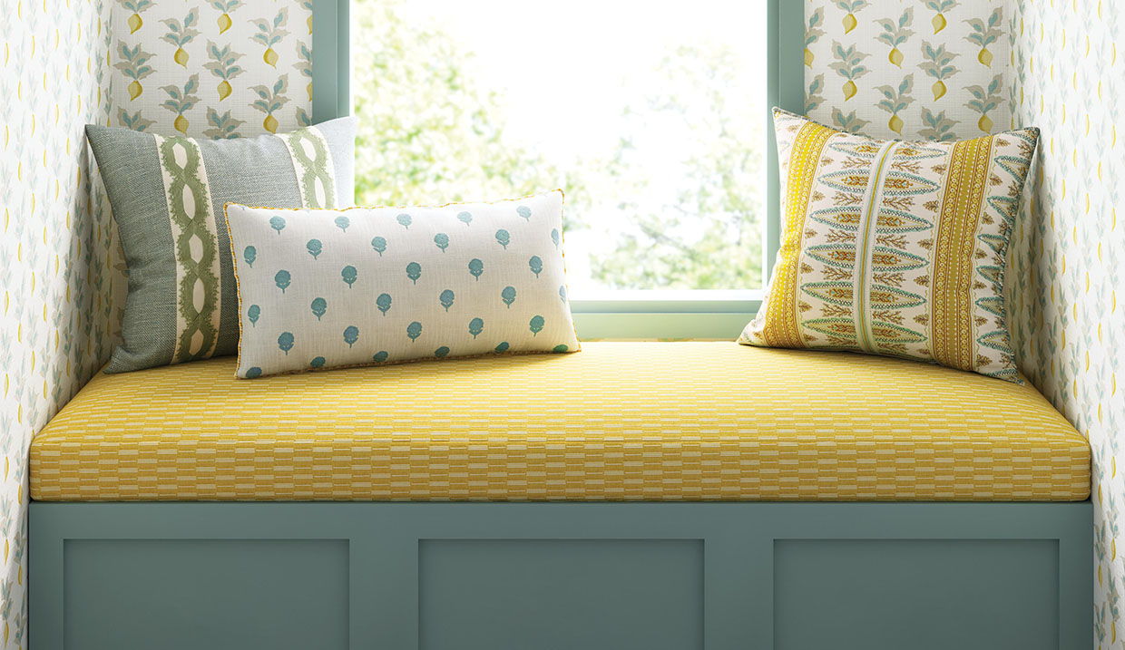 Slipcovers on pillows on yellow bench in house